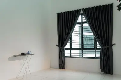 a large window with black curtains in a room at SpaciousFun4BR Home 9Pax 3Bath Snooker ALMA in Bukit Mertajam