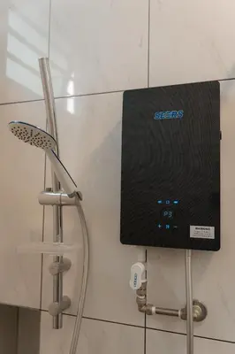 a speaker on a wall next to a chair at SpaciousFun4BR Home 9Pax 3Bath Snooker ALMA in Bukit Mertajam