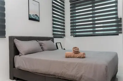 a bedroom with a bed with a towel on it at SpaciousFun4BR Home 9Pax 3Bath Snooker ALMA in Bukit Mertajam