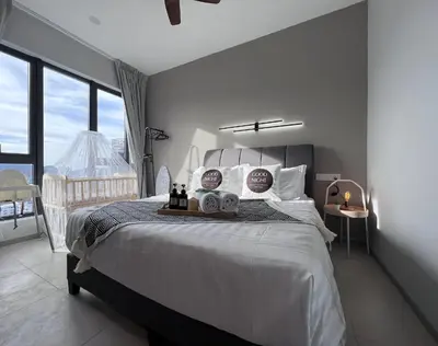 a bedroom with a large bed and a balcony at NEW Georgetown 22 Macalisterz Elegant 2BR 5pax in George Town