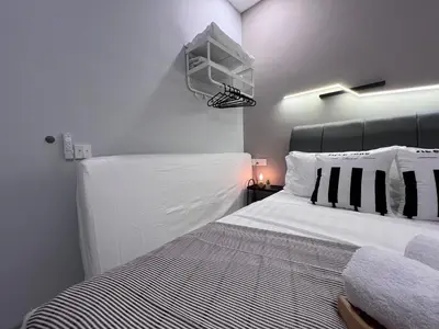 a bedroom with a white bed with a black headboard at NEW Georgetown 22 Macalisterz Elegant 2BR 5pax in George Town
