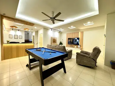 a living room with a ping pong table at Klebang Cozy Homestay in Chemor