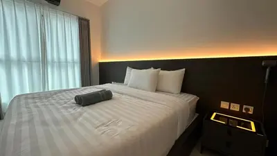 a bed in a hotel room with a bag on it at Ipoh city view Luxury suites near Ipoh Parade in Ipoh