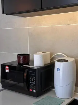 a microwave on a counter with a roll of paper towels at Ipoh city view Luxury suites near Ipoh Parade in Ipoh
