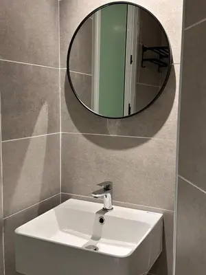 a bathroom with a sink and a mirror on the wall at Ipoh city view Luxury suites near Ipoh Parade in Ipoh