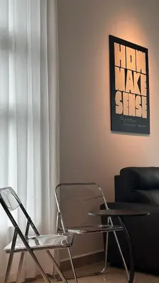 two chairs and a table in a room with a couch at Ipoh city view Luxury suites near Ipoh Parade in Ipoh