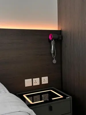 a room with a bed and a table with a light at Ipoh city view Luxury suites near Ipoh Parade in Ipoh
