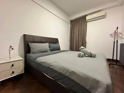 a bedroom with a bed and a dresser and a window at Spacious Comfy 8pax, 3 Bedroom, 2 Car Park, The Landmark in Tanjong Tokong