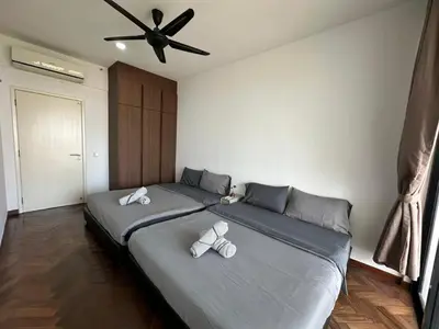 a bedroom with two beds and a ceiling fan at Spacious Comfy 8pax, 3 Bedroom, 2 Car Park, The Landmark in Tanjong Tokong