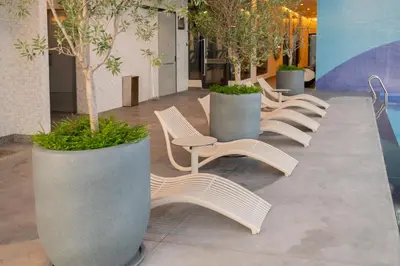a row of chairs and trees in a building at 22 Macalisterz George Town By Mana-Mana in George Town