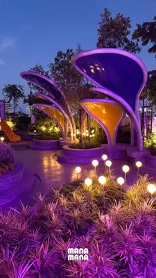 a group of three fountains in a park at night at 22 Macalisterz Leisure Suites George Town in George Town