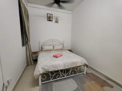 a small bedroom with a bed with a pink bag on it at Aplan Falim by Irainbow in Ipoh
