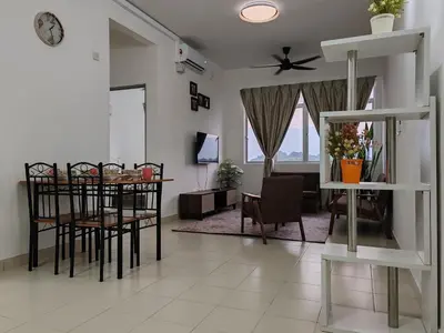 a living room with a table and chairs and a dining room at Aplan Falim by Irainbow in Ipoh