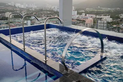a swimming pool on a building with waves in it at 22 Macalisterz George Town By KLIQ in George Town