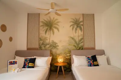 a room with two beds and a ceiling fan at 22 Macalisterz George Town By KLIQ in George Town