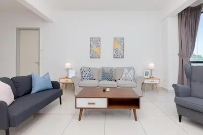 a living room with two couches and a coffee table at Jazz Service Suite Penang in Tanjong Tokong