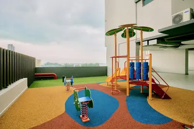 a play area with several childrens playground equipment at Jazz Service Suite Penang in Tanjong Tokong