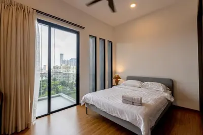 a bedroom with a bed and a large window at Beacon Executive Service Suite Penang in George Town
