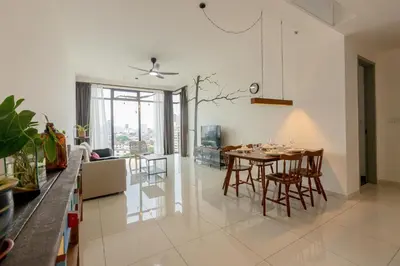 a dining room and living room with a table and chairs at Beacon Executive Service Suite Penang in George Town