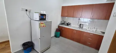 a small kitchen with a refrigerator and a microwave at A357 Silverpark Resort Best Mountain view in Bukit Fraser