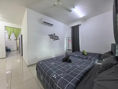 two beds sitting in a room with a hallway at Padang Serai Wangi Homestay 402 in Padang Serai
