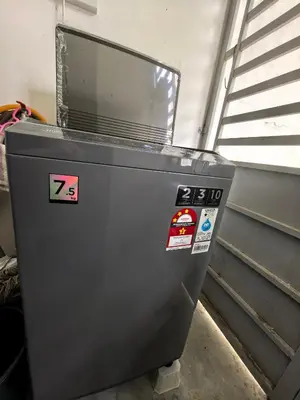 a machine with stickers on it in a room at Padang Serai Wangi Homestay 402 in Padang Serai