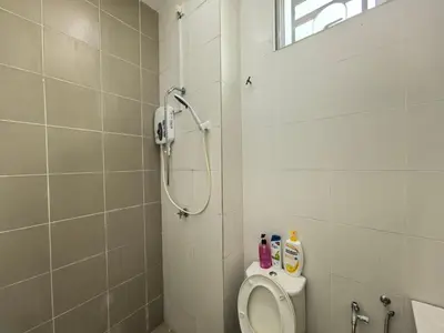 a bathroom with a shower and a toilet in it at Padang Serai Wangi Homestay 402 in Padang Serai