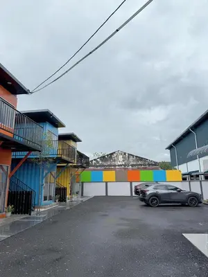 a car parked in a parking lot next to buildings at 69 Comfortainer Homestay in Taiping