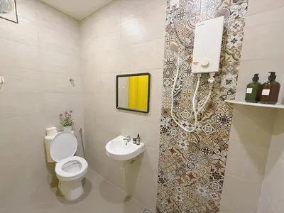 a bathroom with a toilet and a sink at 69 Comfortainer Homestay in Taiping