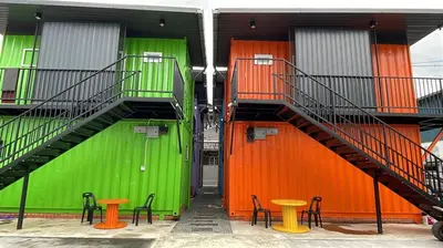 a building with stairs and tables in front of it at 69 Comfortainer Homestay in Taiping