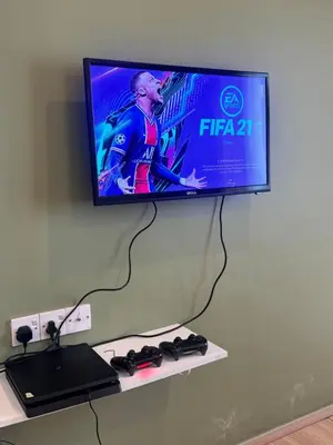 a flat screen tv hanging on a wall at AYAAN Luxe Premium FIFA house with Free WiFi and Netflix in Tanah Rata