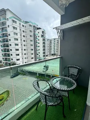 a balcony with a table and chairs and a view of the ocean at AYAAN Luxe Premium FIFA house with Free WiFi and Netflix in Tanah Rata