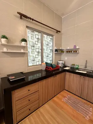 a kitchen with a black counter and a window at AYAAN Luxe Premium FIFA house with Free WiFi and Netflix in Tanah Rata