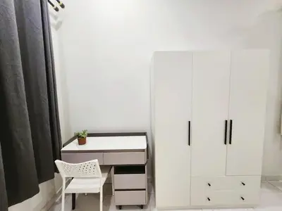 a white desk with a chair and a white cabinet at Ipoh Seri Botani 5br22 pax bbq mahjong in Kampong Kepayang
