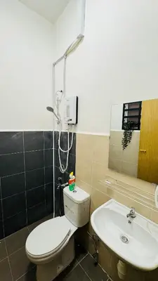 a bathroom with a toilet and a sink at 122 SEGARi in Lumut