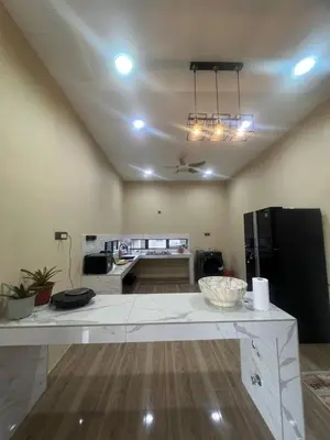 a kitchen with a large white table in a room at MY LENA Villa in Baling