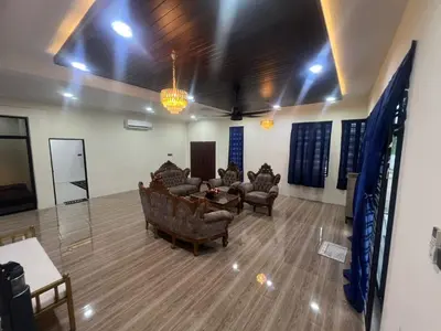 a living room with couches and a table and chairs at MY LENA Villa in Baling