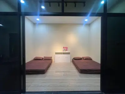 two beds in a room with blue lights at MY LENA Villa in Baling