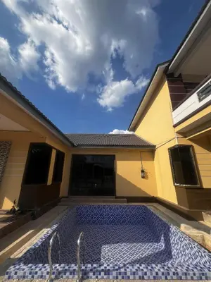 a swimming pool in the backyard of a house at MY LENA Villa in Baling