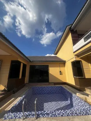 a swimming pool in the courtyard of a house at MY LENA Villa in Baling