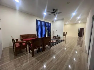 a living room with a table and chairs and a ceiling fan at MY LENA Villa in Baling