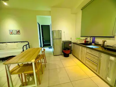 a kitchen with a table and a refrigerator at Stylish 3BR Retreat w Stunning Sea Views Fits 10 A29 in George Town