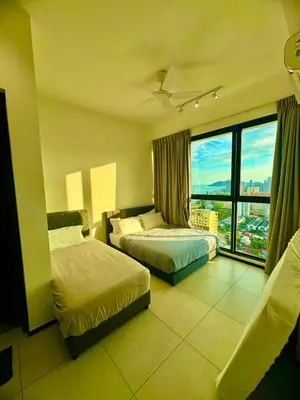 a hotel room with two beds and a large window at Luxury 3BR Seaview Getaway Perfect for 10 Guests A29 in George Town