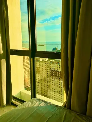 a bedroom with a view of the ocean from a window at Luxury 3BR Seaview Getaway Perfect for 10 Guests A29 in George Town