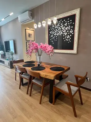 a dining room table with pink flowers in a vase at Master Bedroom only in Bayan Lepas Share Space in Bayan Lepas