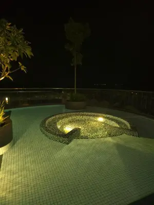 a swimming pool with lights in the middle at night at Master Bedroom only in Bayan Lepas Share Space in Bayan Lepas