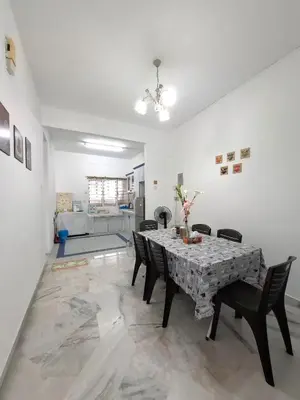 a dining room with a table and chairs at Acacia Guesthouse by ZamanJa in Ipoh