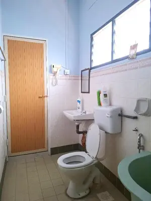 a bathroom with a toilet and a sink and a window at Acacia Guesthouse by ZamanJa in Ipoh