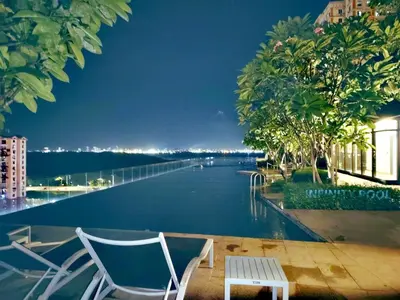 a couple of chairs sitting next to a swimming pool at Luxe 3BR Seaview Escape Sleeps 10 Prime Location A29 in George Town