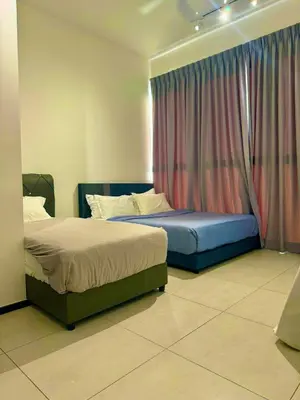 two beds sitting in a bedroom with a window at 3BR Seaside Oasis Sleeps 10 Chic & Spacious A29 in George Town